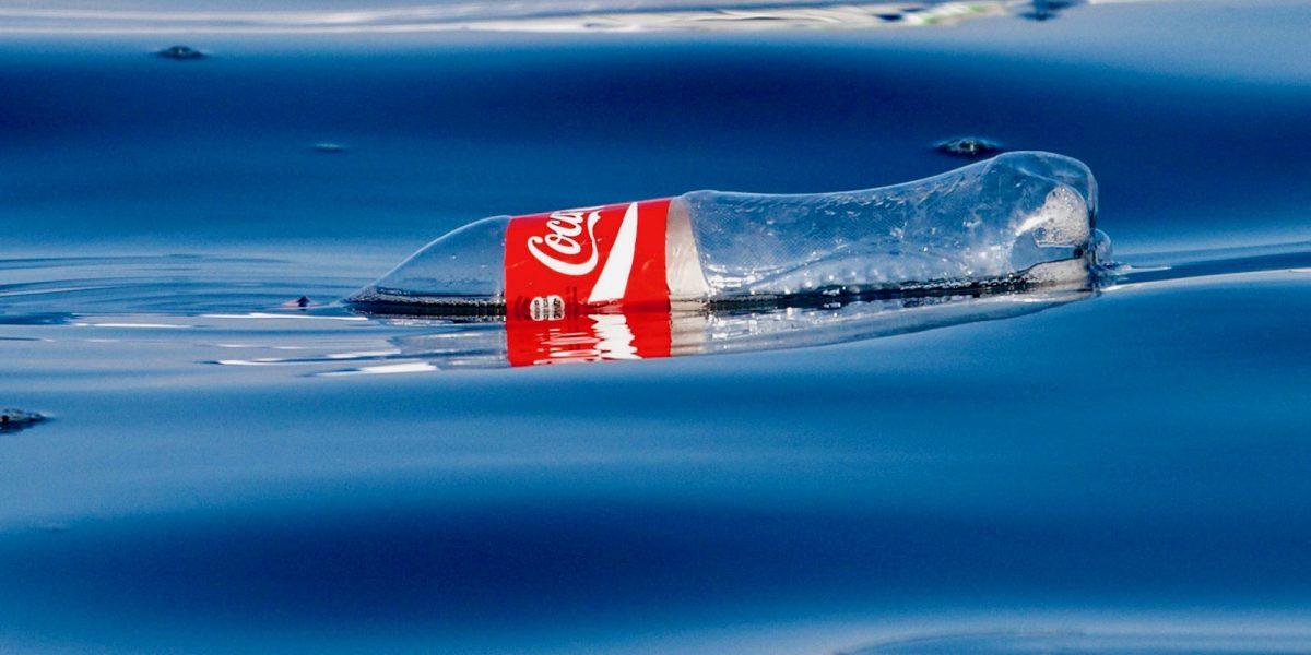 A plastic Coke bottle floats in the Pacific Ocean.