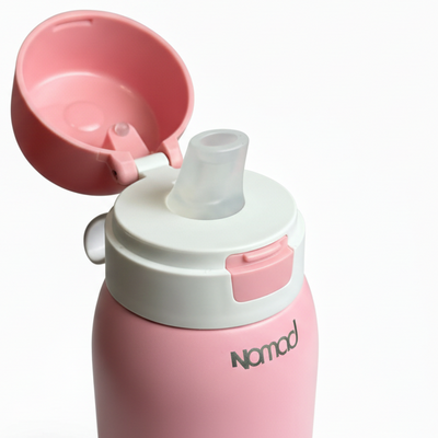 Pink safesip filtered water bottle with a white cap and pink lid on a white surface. 