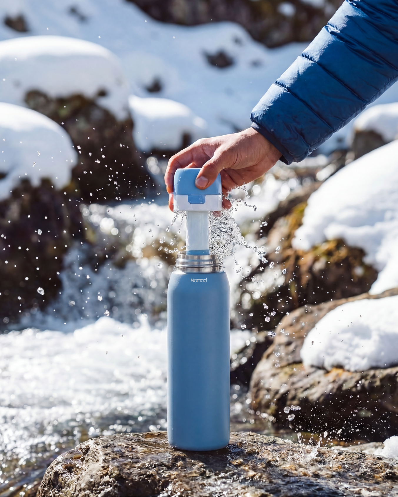 Person using a SafeSip water filter bottle in a snowy outdoor setting